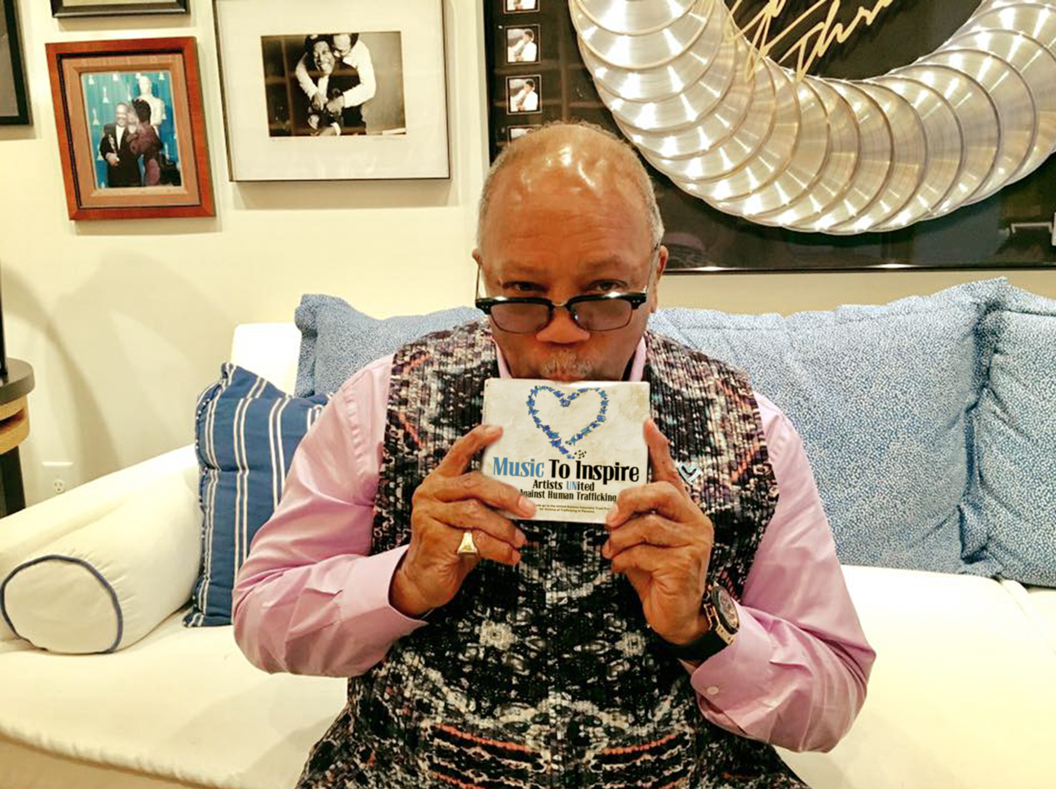 Quincy Jones holding the Music To Inspire album